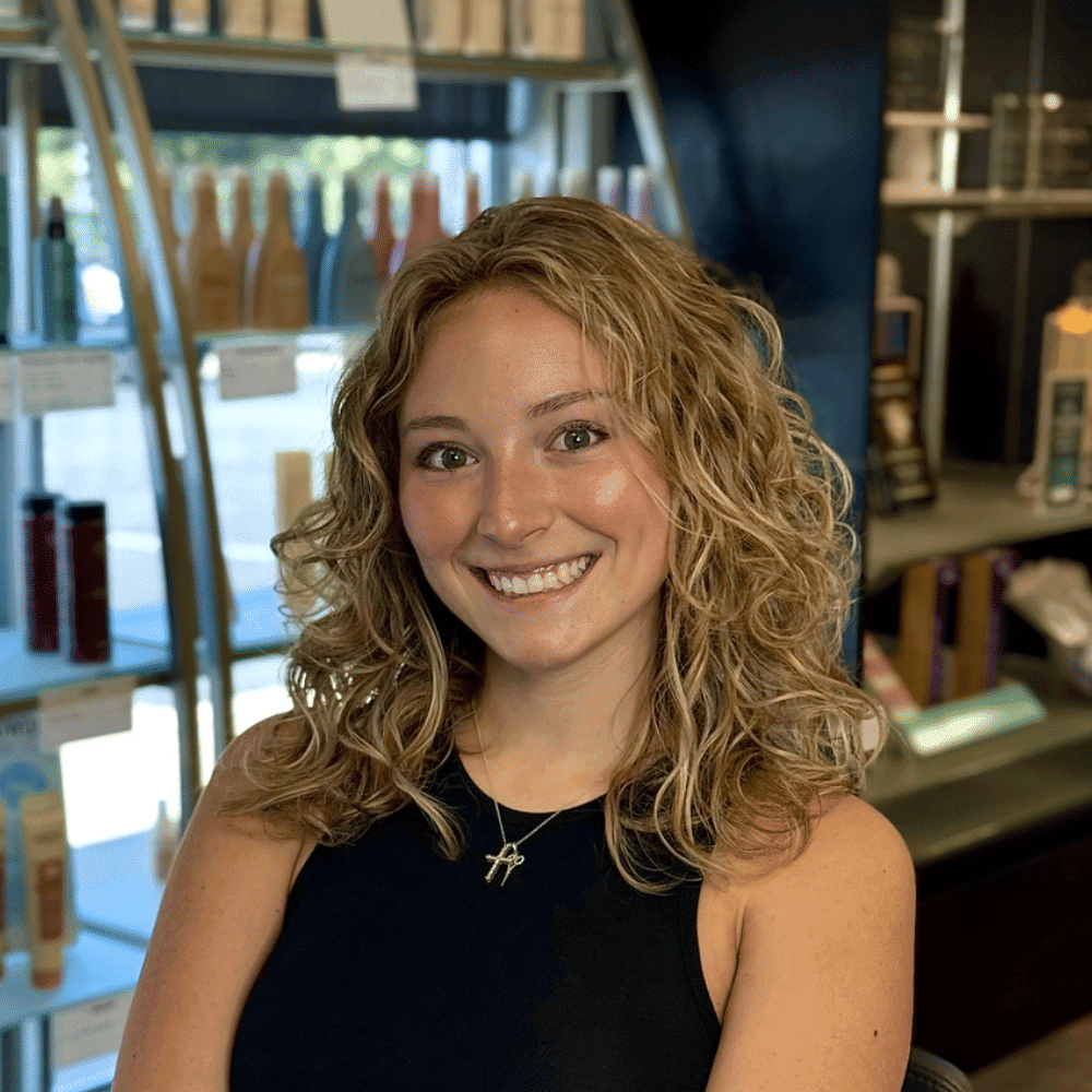 Portrait of Sienna, a professional stylist at Platinum Hair Salon, showcasing their expertise and style.