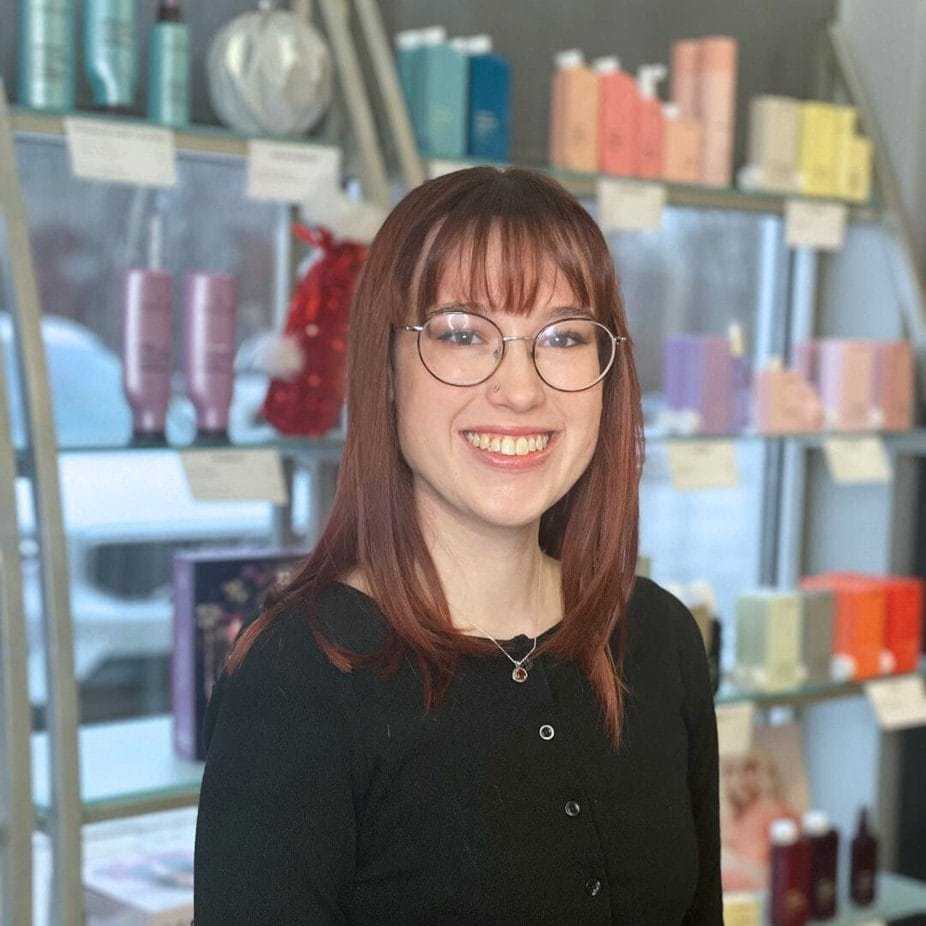 Portrait of Faith, a professional stylist at Platinum Hair Salon, showcasing their expertise and style.